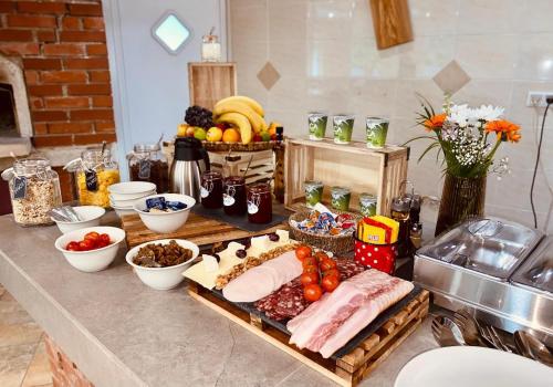 a table with a bunch of food on a counter at Zelena Oaza in Zgornja Kungota