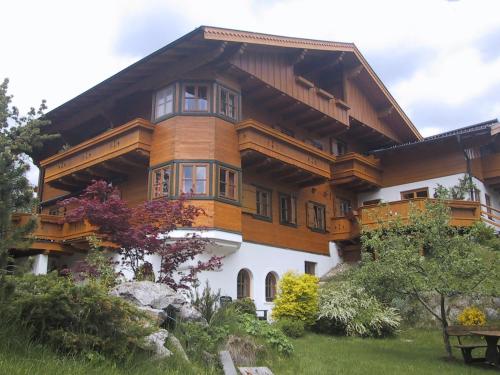 a large wooden house with a balcony at Landhaus Lisa in Schladming