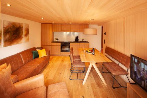 a living room with a couch and a table at Alpin Aparts in Mellau