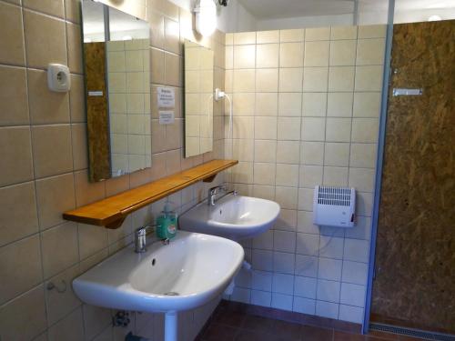 a bathroom with two sinks and a mirror at Farmer's Room at Sedliacky Dvor - Brezno in Brezno