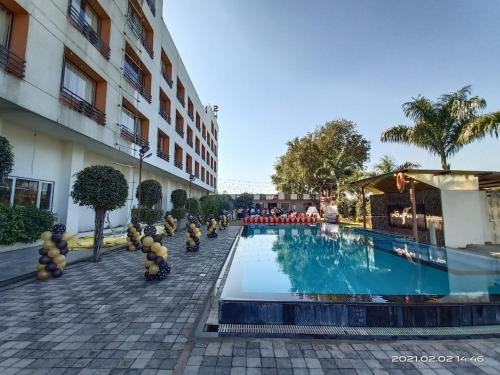 a pool at a hotel with stuffed animals around it at Solitaire Hotel And Resorts in Ujjain