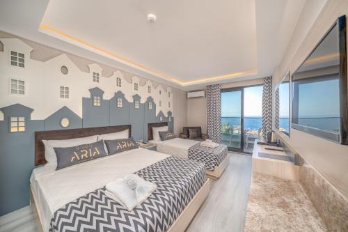 a bedroom with two beds and a large window at ARIA RESORT & SPA HOTEL Ultra All Inclusive in Konaklı