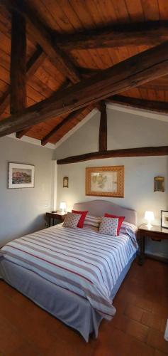 a bedroom with a large bed with red pillows at Altana Sul Tetto in Bologna