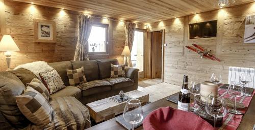 un salon avec un canapé et une table dans l'établissement Chalet Miravidi, Montchavin-La Plagne, Jacuzzi & Sauna, à Montchavin