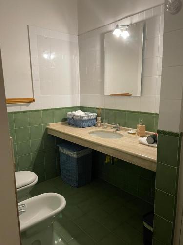 a bathroom with a sink and a toilet and a mirror at Ad Maiora Salento in Lecce