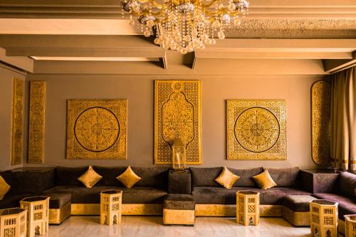 a living room with a couch and a chandelier at HAMILTON Agadir in Agadir