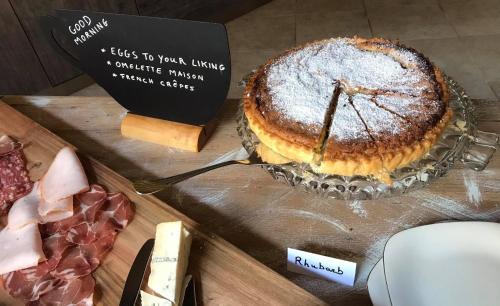 a cake sitting on a table next to a sign at Ta Marie Merhba in Żebbuġ