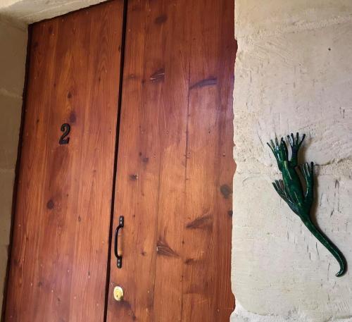 a wooden door with the number two on a wall at Ta Marie Merhba in Żebbuġ