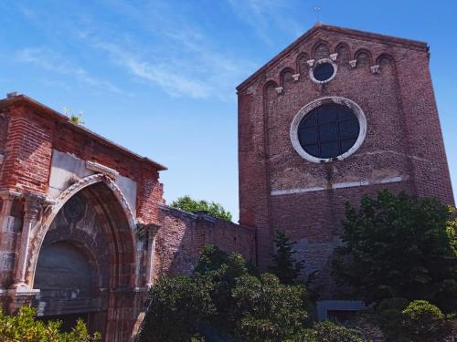 
a large brick building with a clock on it at Ostello S. Fosca - CPU Venice Hostels in Venice
