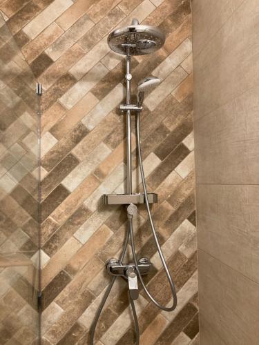 a shower with a glass door in a bathroom at Prison de la Mer in 2 Mai