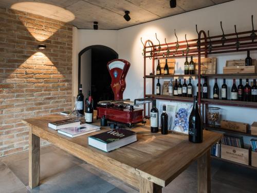 a room with a wooden table with bottles of wine at Ferienwohnungen am Lochbach in Aschau im Chiemgau