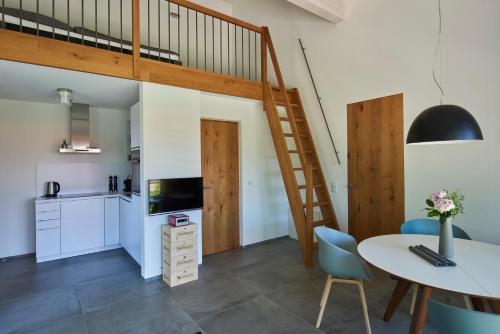 a kitchen and dining room with a loft bed at Ferienwohnungen am Lochbach in Aschau im Chiemgau