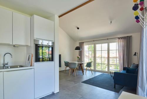 a kitchen and living room with a table and chairs at Ferienwohnungen am Lochbach in Aschau im Chiemgau