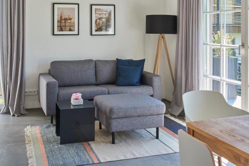 a living room with a couch and a chair at Ferienwohnungen am Lochbach in Aschau im Chiemgau