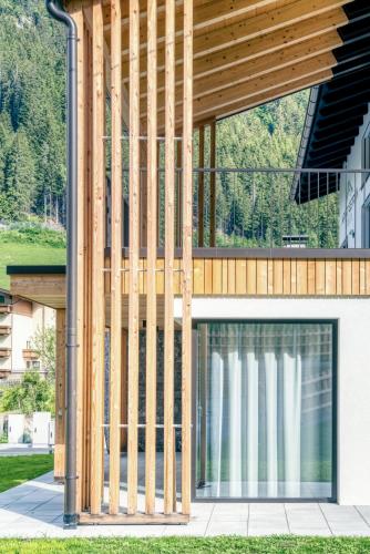 a timber building with a large window at Apart Gstrein - including Silvretta Premium Summercard in See