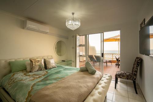 a bedroom with a bed with a view of the ocean at Ocean blues Isikhulu 7 in Umdloti