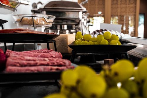 a buffet with meat and other food on display at SUHA Mina Rashid Hotel Apartments in Dubai