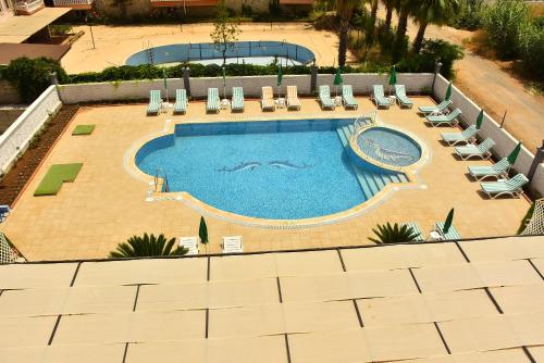 an overhead view of a large swimming pool with lounge chairs at Nora Suit Hotel in Side