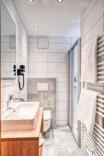 a bathroom with a sink and a toilet at Apart Gstrein - including Silvretta Premium Summercard in See