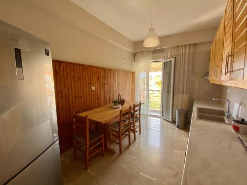 a kitchen with a wooden table and some chairs at Blu Blu apartment with castle view in Koroni