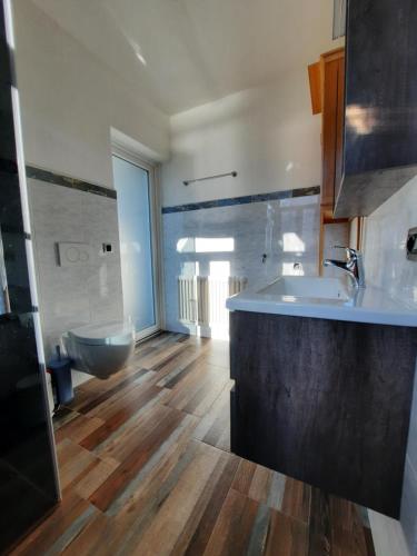 een badkamer met een wastafel en een toilet. bij Casa Vacanze - Casa Quattro Luci in Tronzano Lago Maggiore