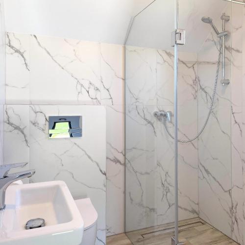 a bathroom with a shower and a sink at Domki Nord Star in Władysławowo