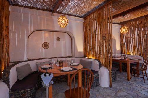 a restaurant with two tables and chairs in a room at Hotel Sunshine in Kamari