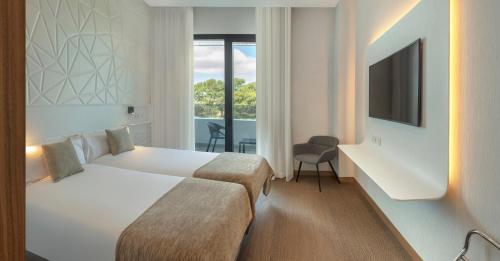 A bed or beds in a room at AJ Gran Alacant by SH Hoteles