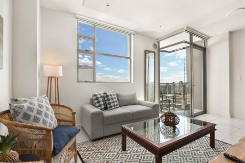 a living room with a couch and a table at The Median Apartments in Johannesburg