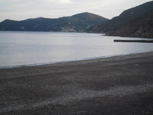 a view of a beach with mountains in the background at Appartamenti Claudia Rio in Rio Marina