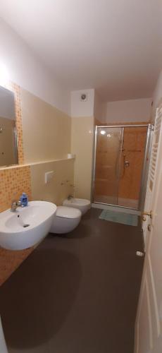 a bathroom with two toilets and a sink and a shower at Casa per ferie religiosa Figlie di Nazareth in Pisa