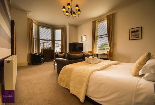a bedroom with a bed and a living room at Rowntree Lodge in Scarborough