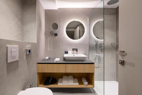 a bathroom with a sink and a shower at Amphora's Garden in Split
