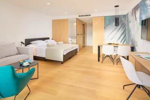 a hotel room with a bed and a table and chairs at Amphora's Garden in Split