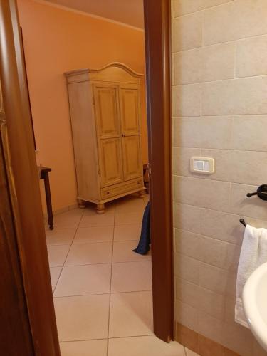 a bathroom with a sink and a cabinet at Sole del Mediterraneo in Otranto