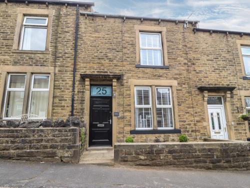a brick building with a door with the number at Acorn Cottage in Skipton