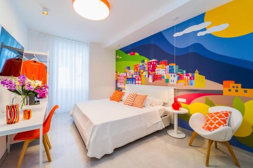 a bedroom with a bed and a colorful wall at Amalfi Centro in Amalfi