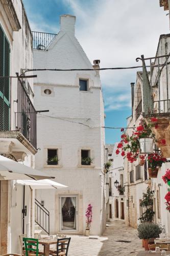 an alley in an old town with tables and chairs at 1783 Dimora d'Epoca in Locorotondo