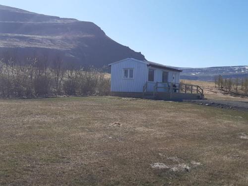 a small white house in a field of grass at Hagi 2 Road 62 nr 2 in Hagi