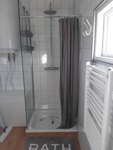a shower with a shower curtain in a bathroom at Hagi 2 Road 62 nr 2 in Hagi