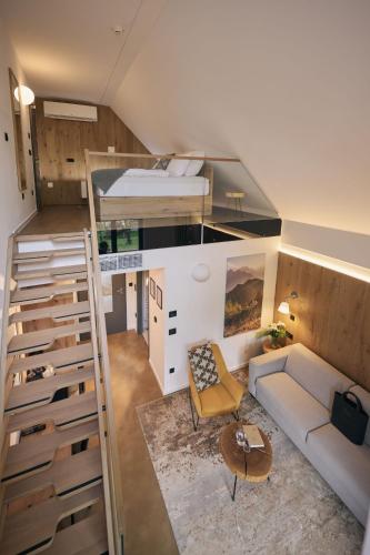 a small room with a bunk bed and a couch at Triangel Boutique Hotel in Kranjska Gora