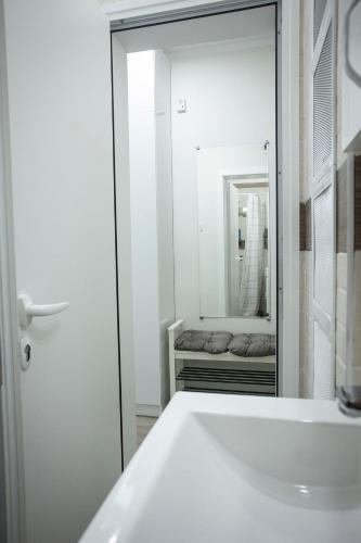 a bathroom with a white sink and a mirror at Landmark 1BDR Apartment in Center, next to Metro in Sofia