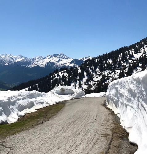 a dirt road with snow on the side of a mountain at Mountain Penthouse Top 8 & 9 in Fügen