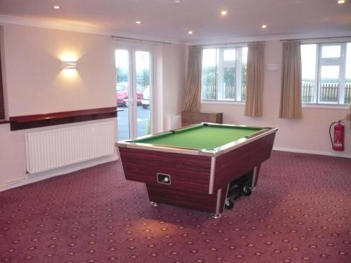 a large room with a pool table in it at Tri-Star Hotel in Birmingham