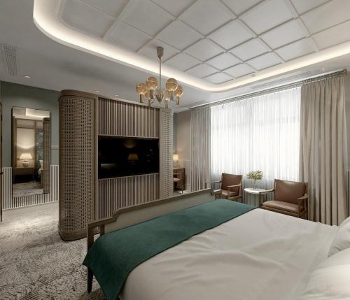 a bedroom with a large bed and a television at La Passion Hanoi Hotel & Spa in Hanoi