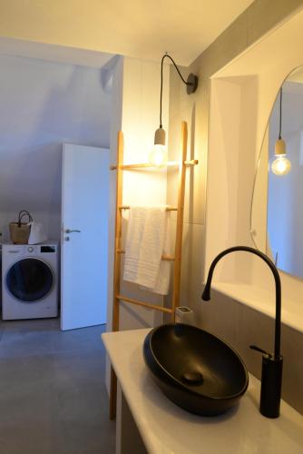 a kitchen with a black sink on a counter at Despoina Apartment in Patitiri