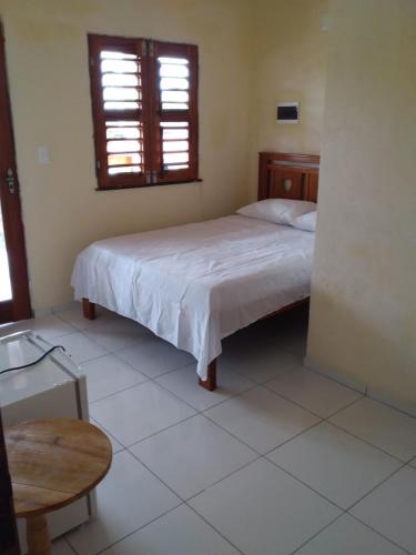 Ein Bett oder Betten in einem Zimmer der Unterkunft Suíte das flores em Guajiru