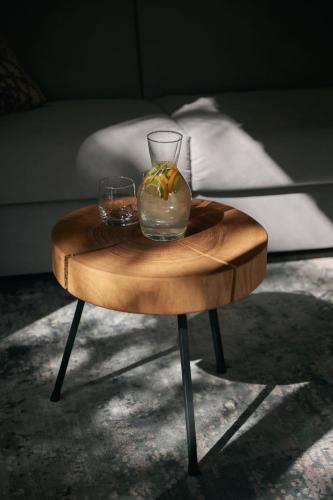 a wooden table with two glasses on top of it at Triangel Boutique Hotel in Kranjska Gora
