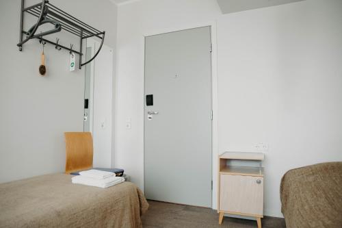 a room with a bed and a table and a door at Hostel Tartu in Tartu