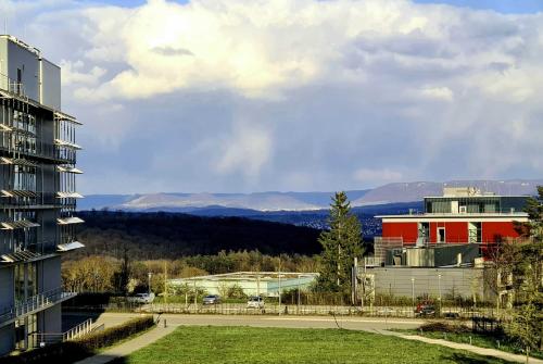 a view of a city with a building and a park at KONCEPT HOTEL Neue Horizonte in Tübingen